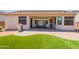 Backyard with brick patio, artificial turf, bbq, covered area, and seating at 18226 W Stinson Dr, Surprise, AZ 85374