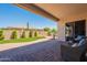 Backyard with covered patio, outdoor seating, bbq, artificial turf, and desert landscaping at 18226 W Stinson Dr, Surprise, AZ 85374