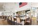Clubhouse interior with bar area, lots of seating and American flag on the wall at 18226 W Stinson Dr, Surprise, AZ 85374