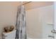 Clean bathroom with shower and tub combo, neutral walls, and decorative curtain at 18226 W Stinson Dr, Surprise, AZ 85374