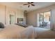 Bright bedroom featuring a sliding glass door to the patio, and neutral colored walls and carpeting at 18226 W Stinson Dr, Surprise, AZ 85374