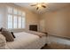 Bedroom with ceiling fan, large window with shutters, neutral walls, and carpet floors at 18226 W Stinson Dr, Surprise, AZ 85374
