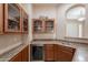 Beverage bar complete with wine fridge, sink, storage, and granite countertops at 18226 W Stinson Dr, Surprise, AZ 85374