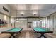 An elegant billiard room with two pool tables, perfect for entertainment and recreation at 18226 W Stinson Dr, Surprise, AZ 85374