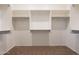 Large walk-in closet featuring carpeted floor, white shelving, and rod storage at 18226 W Stinson Dr, Surprise, AZ 85374