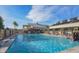 A large, inviting community pool with comfortable lounge chairs under a sunny sky at 18226 W Stinson Dr, Surprise, AZ 85374