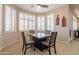 Bright dining room with tiled floor, modern table and chairs, and plantation shutters at 18226 W Stinson Dr, Surprise, AZ 85374
