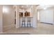 Foyer with tiled floor, arched entryway, a beverage bar, and double front doors with a storm door at 18226 W Stinson Dr, Surprise, AZ 85374