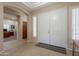 Welcoming foyer with tiled floor, arched entryway, and double front doors with window shutters for added privacy at 18226 W Stinson Dr, Surprise, AZ 85374