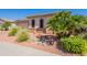 Charming single-story home with desert landscaping, including palm trees, rocks, and low-water plants at 18226 W Stinson Dr, Surprise, AZ 85374