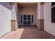 Inviting front porch with brick paving, security door, and stylish overhead lighting at 18226 W Stinson Dr, Surprise, AZ 85374