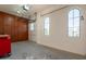 Spacious garage featuring storage cabinets, arched windows and work table, providing ample space for parking and hobbies at 18226 W Stinson Dr, Surprise, AZ 85374