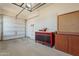 Clean garage with ample space, peg board, rolling tool box, and storage cabinets providing room for vehicles and storage at 18226 W Stinson Dr, Surprise, AZ 85374