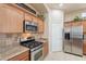 Well-equipped kitchen featuring granite counters, stainless appliances, and ample cabinetry at 18226 W Stinson Dr, Surprise, AZ 85374