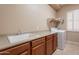 Functional laundry room with utility sink, ample counter space, and modern washer and dryer at 18226 W Stinson Dr, Surprise, AZ 85374