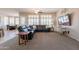 Cozy living room with plush carpeting, a comfortable sectional sofa, and ample natural light from the windows at 18226 W Stinson Dr, Surprise, AZ 85374