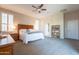 Large main bedroom suite featuring neutral walls, plantation shutters, and a ceiling fan at 18226 W Stinson Dr, Surprise, AZ 85374