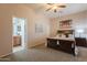 Comfortable main bedroom with carpet, ceiling fan, connecting bath, and warm neutral tones at 18226 W Stinson Dr, Surprise, AZ 85374
