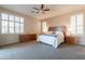 Spacious main bedroom suite featuring neutral walls, plantation shutters, and a ceiling fan at 18226 W Stinson Dr, Surprise, AZ 85374