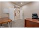 Home office with built-in desk, white board, and french door entry at 18226 W Stinson Dr, Surprise, AZ 85374