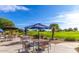 Outdoor seating area with tables, chairs, and golf course views on a bright day at 18226 W Stinson Dr, Surprise, AZ 85374