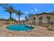 Community swimming pool with lounge chairs and fenced enclosure on a sunny day at 18226 W Stinson Dr, Surprise, AZ 85374
