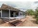 Spacious backyard featuring covered patio, brick accent, and a comfortable hammock at 2019 W Stella Ln, Phoenix, AZ 85015