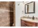 Bathroom with tiled shower and vanity with granite countertop at 2019 W Stella Ln, Phoenix, AZ 85015