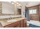 Bright bathroom featuring double sinks, granite counters and tiled shower/bath at 2019 W Stella Ln, Phoenix, AZ 85015