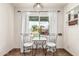 Cozy breakfast nook with decorative curtains and an industrial-style light fixture at 2019 W Stella Ln, Phoenix, AZ 85015