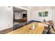 Open dining space featuring a wood table, black chairs, and access to the living area at 2019 W Stella Ln, Phoenix, AZ 85015
