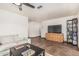 Cozy living room featuring modern furniture, tile flooring, and a shelving unit at 2019 W Stella Ln, Phoenix, AZ 85015