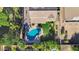 Overhead view of a property with a pool, patio, manicured lawn, and playset at 21266 S 213Th Pl, Queen Creek, AZ 85142