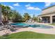 Inviting backyard showcasing the pool, lush landscaping, and ample space for outdoor relaxation at 21266 S 213Th Pl, Queen Creek, AZ 85142
