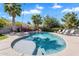 Beautiful backyard pool with palm trees, manicured landscaping, and lounge chairs under string lights at 21266 S 213Th Pl, Queen Creek, AZ 85142