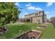 Expansive backyard with lush lawn, garden beds, playset, and a sparkling pool with lounge area at 21266 S 213Th Pl, Queen Creek, AZ 85142
