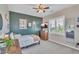 Bedroom featuring natural light, gray carpet, plantation shutters, and green accent wall at 21266 S 213Th Pl, Queen Creek, AZ 85142