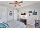 Comfortable bedroom featuring a ceiling fan and mounted TV above a dark wood dresser at 21266 S 213Th Pl, Queen Creek, AZ 85142
