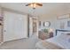 Comfortable bedroom features large closet, ceiling fan and natural light from the windows at 21266 S 213Th Pl, Queen Creek, AZ 85142