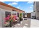 Charming courtyard with decorative wall art, cozy seating, mature plants, and stylish decor at 21266 S 213Th Pl, Queen Creek, AZ 85142