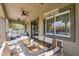 Inviting covered patio with dining set, offering views of the lush backyard and refreshing pool at 21266 S 213Th Pl, Queen Creek, AZ 85142