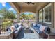 Spacious covered patio featuring comfortable seating around a coffee table on an outdoor rug at 21266 S 213Th Pl, Queen Creek, AZ 85142
