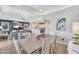 Bright dining area with a neutral color palette, wood table and an open layout to the living area at 21266 S 213Th Pl, Queen Creek, AZ 85142