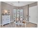 Charming dining nook with a round table, bay window, and storage cabinet at 21266 S 213Th Pl, Queen Creek, AZ 85142