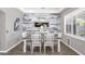 Inviting dining room with a rustic wood table, white chairs, and an accent wall at 21266 S 213Th Pl, Queen Creek, AZ 85142
