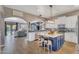Open-concept kitchen featuring a blue island, white cabinets, and seamless flow to the living area at 21266 S 213Th Pl, Queen Creek, AZ 85142