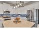 Modern kitchen with stainless steel appliances, marble countertop island, and sleek white cabinetry at 21266 S 213Th Pl, Queen Creek, AZ 85142