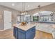 Updated kitchen with white cabinetry, a central island, and an open layout to dining area at 21266 S 213Th Pl, Queen Creek, AZ 85142