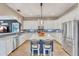Bright kitchen with white cabinetry, a blue island, and stainless steel appliances at 21266 S 213Th Pl, Queen Creek, AZ 85142