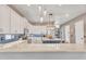 Spacious kitchen with white cabinets, a central island, and stylish pendant lighting at 21266 S 213Th Pl, Queen Creek, AZ 85142